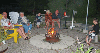 Family enjoying campfire at Maple Court Cottages Port Dover Ontario Canada